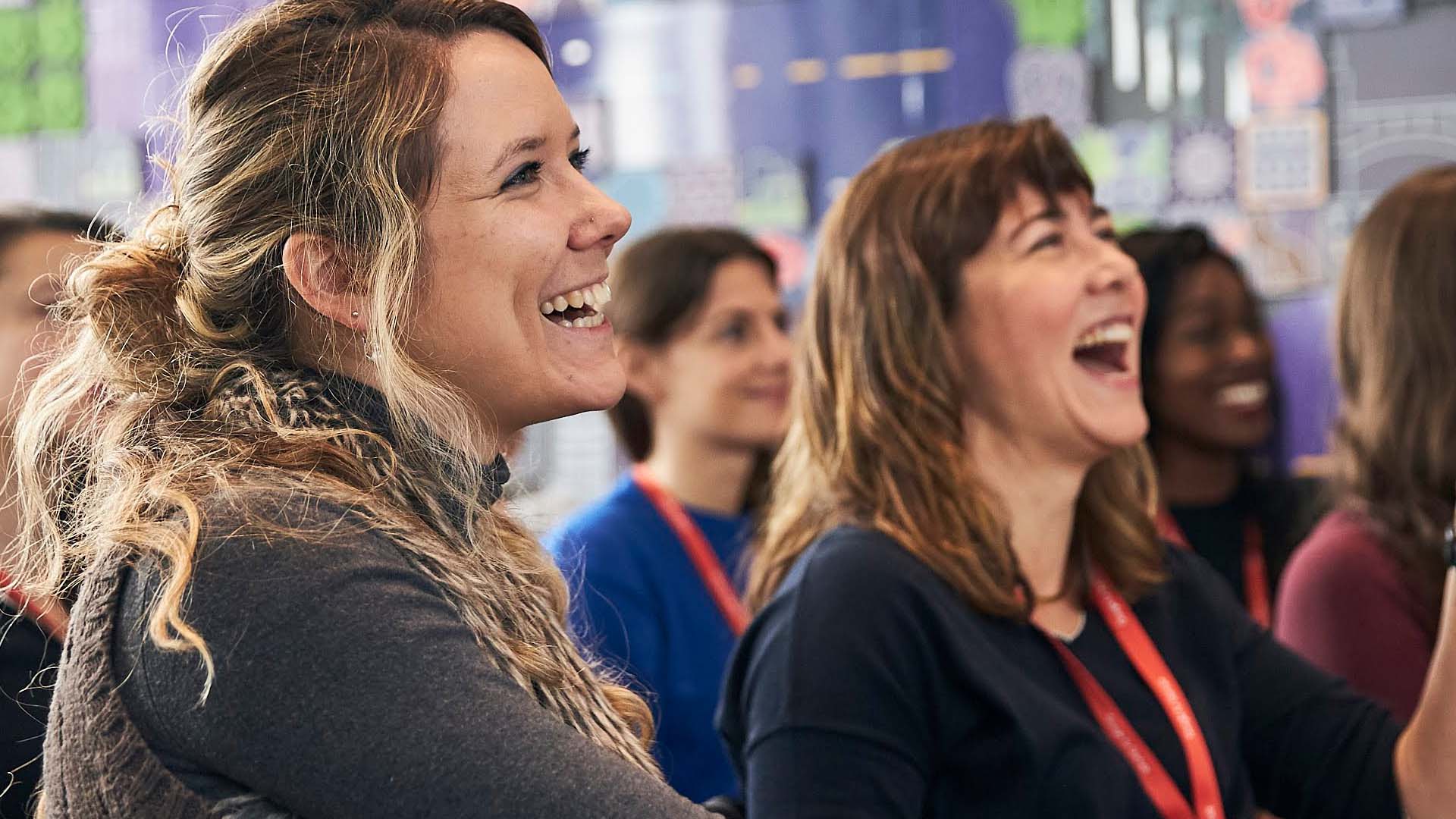 2 women in a conference, laughing